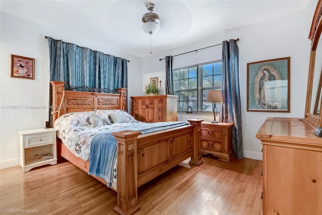 bedroom with baseboards, ceiling fan, and light wood finished floors