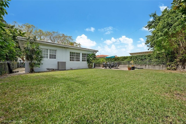 view of yard with central AC, a patio area, and fence