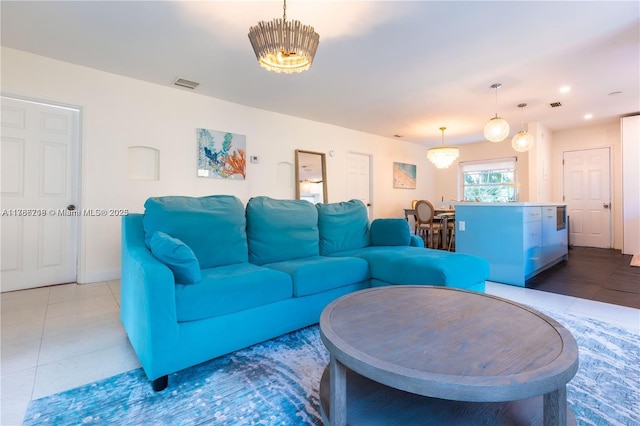 tiled living area with baseboards and visible vents