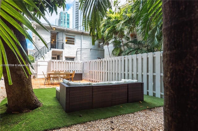 exterior space featuring outdoor lounge area and a fenced backyard