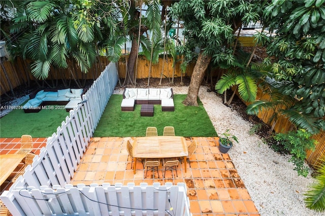 view of yard featuring outdoor lounge area, a fenced backyard, outdoor dining area, and a patio area