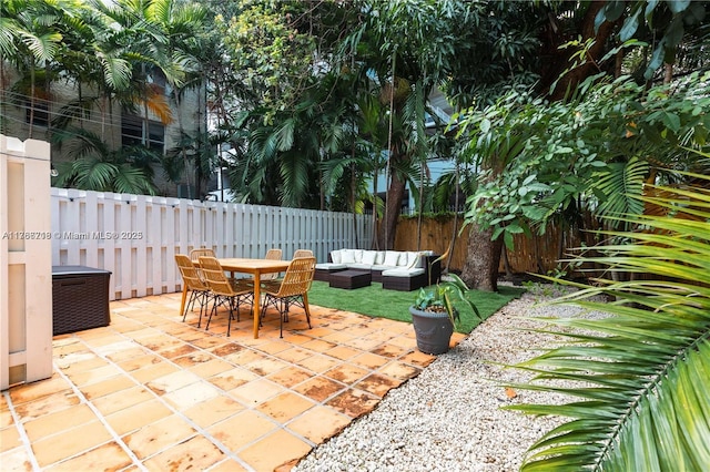 view of patio / terrace with outdoor dining space, an outdoor hangout area, and a fenced backyard