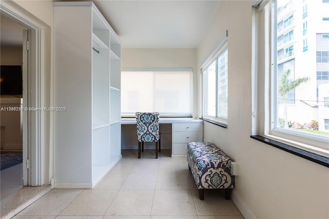interior space featuring baseboards and built in study area