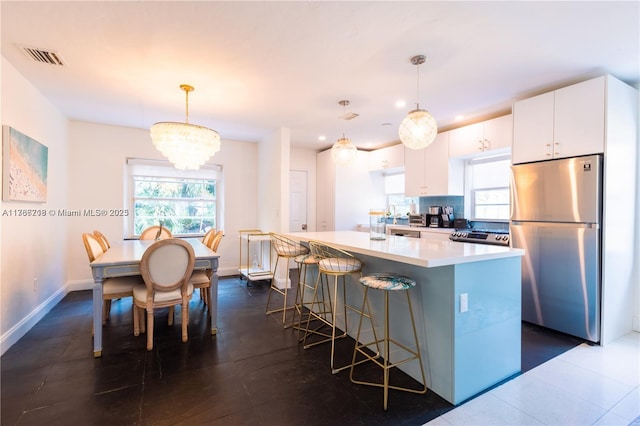 kitchen featuring visible vents, white cabinets, a healthy amount of sunlight, and appliances with stainless steel finishes