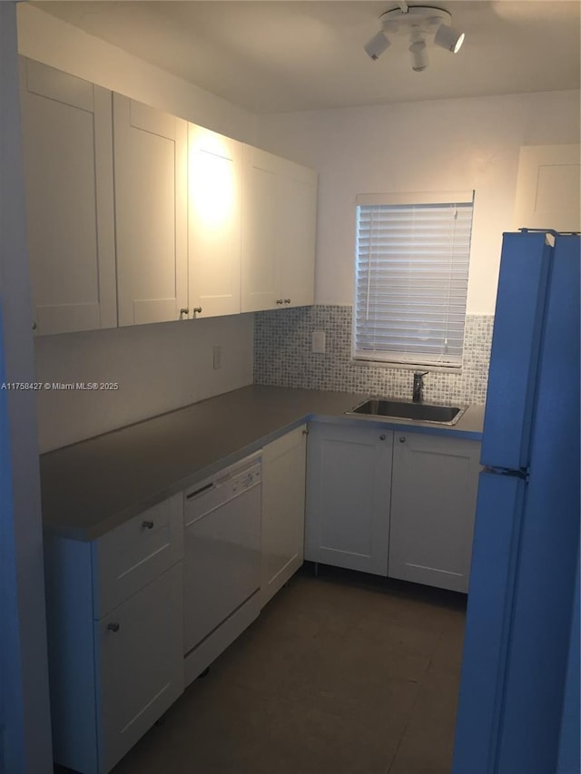 1701 Washington St Unit 503, Hollywood, FL 33020 - kitchen featuring white appliances, a sink, backsplash, and white cabinets