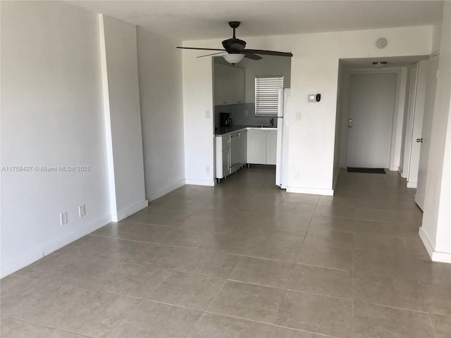 1701 Washington St Unit 503, Hollywood, FL 33020 - unfurnished living room featuring ceiling fan and dark tile patterned flooring