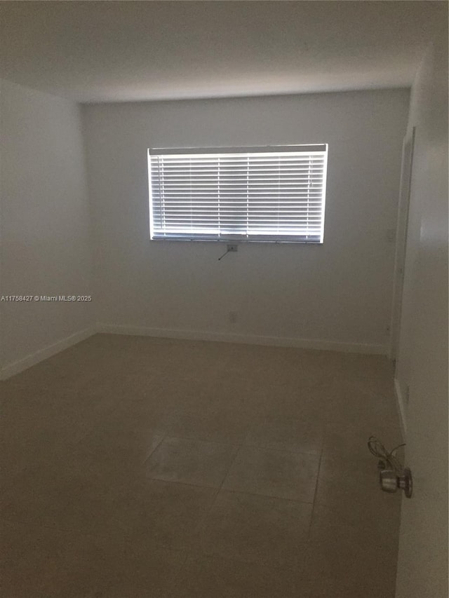 1701 Washington St Unit 503, Hollywood, FL 33020 - empty room featuring tile patterned floors, plenty of natural light, and baseboards