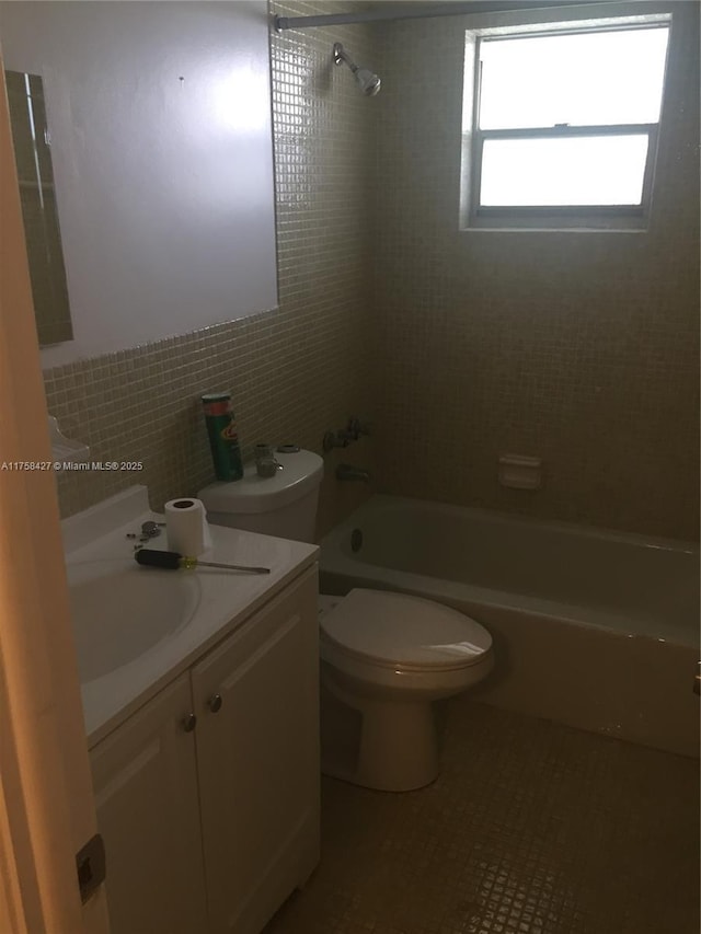 1701 Washington St Unit 503, Hollywood, FL 33020 - bathroom with bathtub / shower combination, vanity, tile walls, toilet, and tile patterned floors