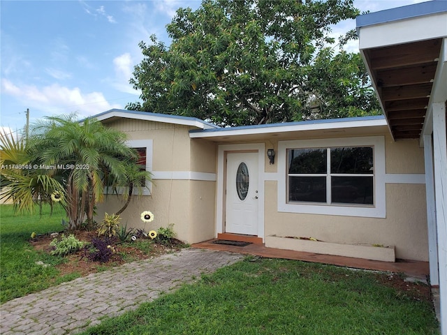 entrance to property with stucco siding