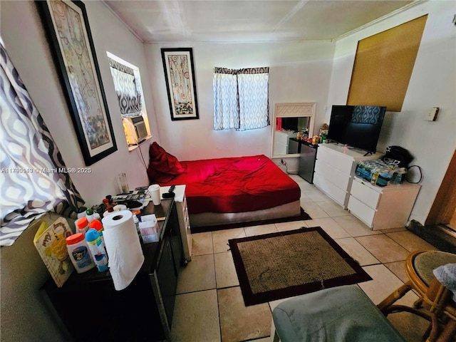 bedroom featuring light tile patterned floors and multiple windows