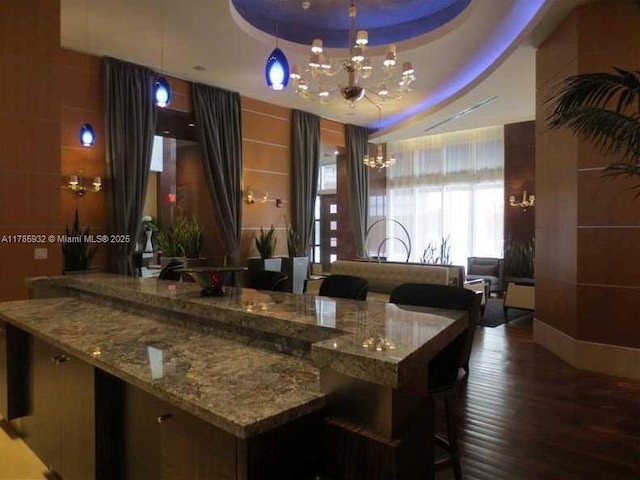 253 NE 2nd St Unit 324, Miami, FL 33132 - bar with a chandelier, a tray ceiling, and wood finished floors