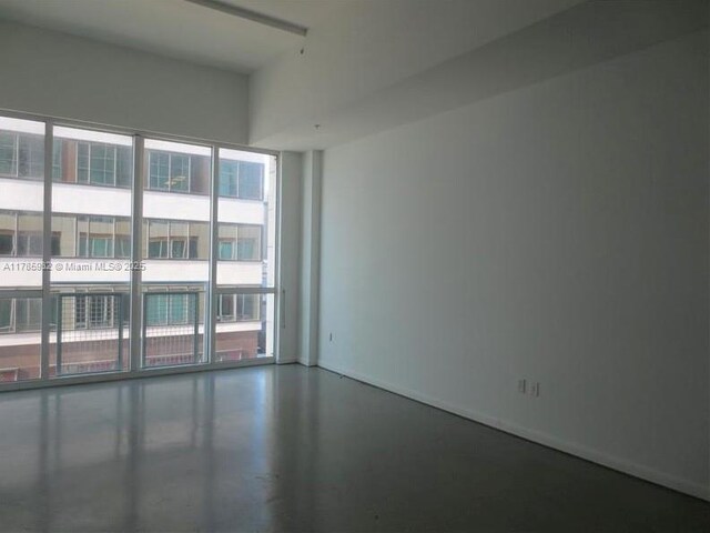 253 NE 2nd St Unit 324, Miami, FL 33132 - spare room featuring finished concrete flooring