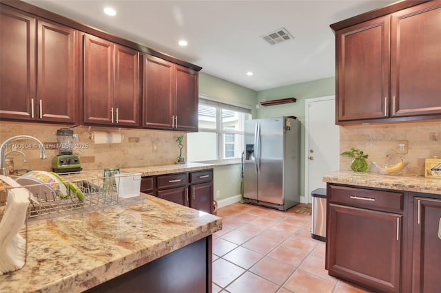 9271 Arborwood Cir, Davie, FL 33328 - kitchen featuring stainless steel fridge, backsplash, light stone countertops, recessed lighting, and light tile patterned floors