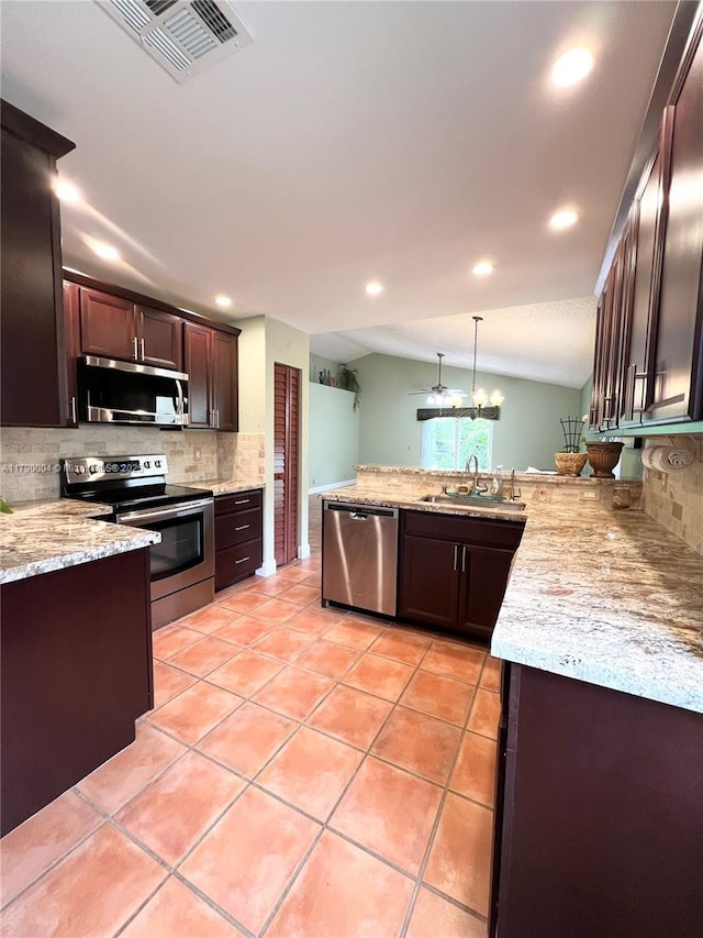 9271 Arborwood Cir, Davie, FL 33328 - kitchen with appliances with stainless steel finishes, backsplash, dark brown cabinets, light tile patterned floors, and light stone counters