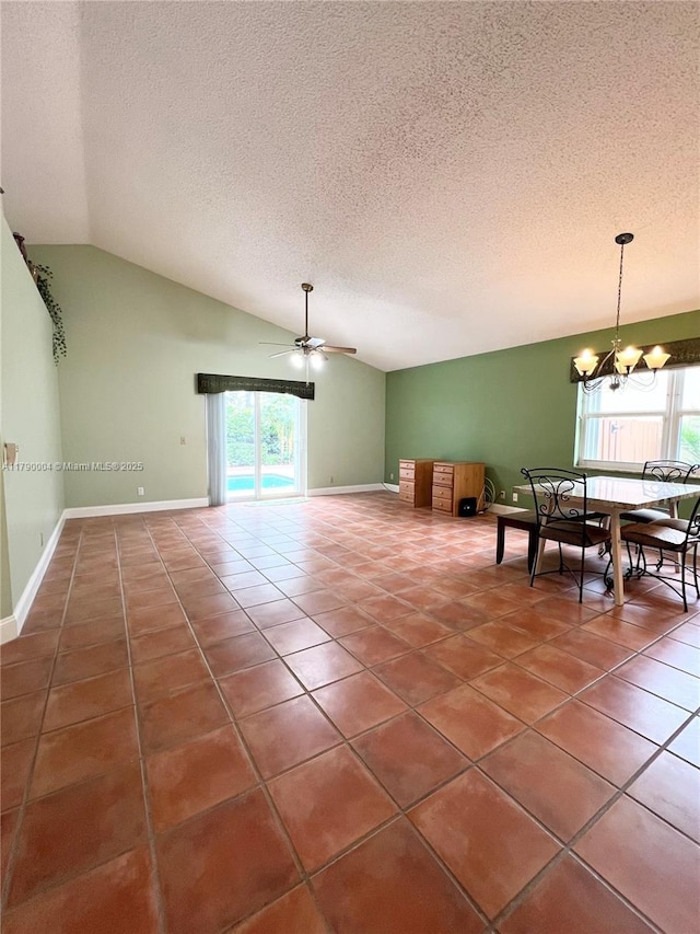 9271 Arborwood Cir, Davie, FL 33328 - dining space with healthy amount of natural light, vaulted ceiling, a ceiling fan, tile patterned flooring, and a textured ceiling