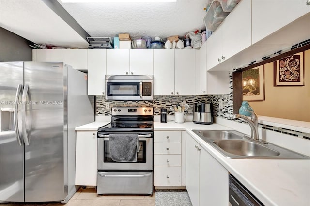 kitchen with light countertops, a sink, and appliances with stainless steel finishes