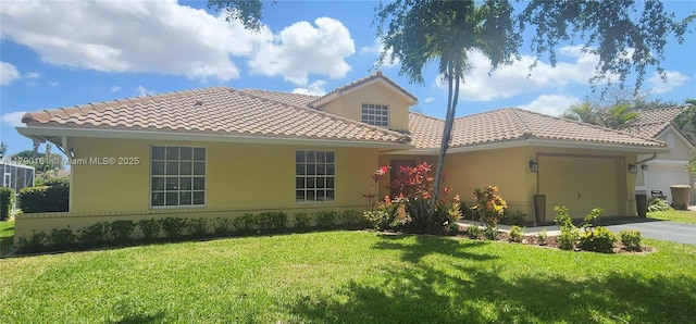 view of front of house with an attached garage, a front lawn, aphalt driveway, and a tiled roof