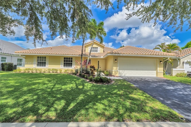 3562 W Southern Orchard Rd W, Davie, FL 33328 - back of property featuring a tiled roof, an attached garage, a lawn, and driveway
