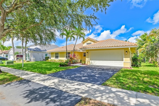 3562 W Southern Orchard Rd W, Davie, FL 33328 - view of front of house featuring asphalt driveway, stucco siding, a front yard, and a garage