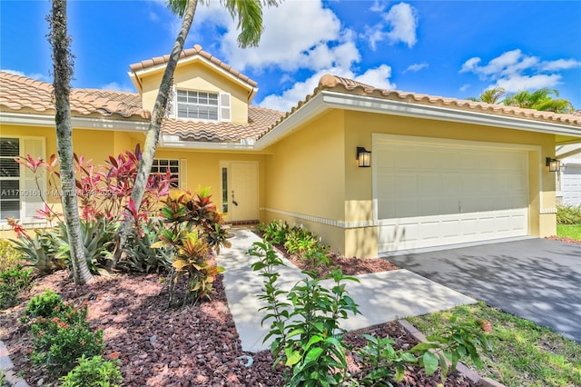 3562 W Southern Orchard Rd W, Davie, FL 33328 - mediterranean / spanish house featuring stucco siding, an attached garage, a tiled roof, and driveway