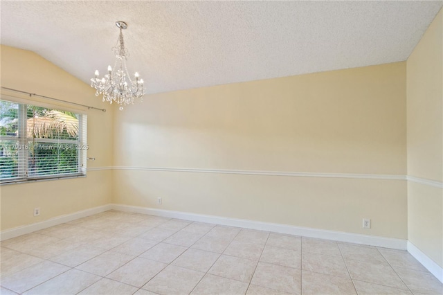 unfurnished room with light tile patterned floors, vaulted ceiling, a textured ceiling, and a chandelier