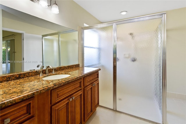 bathroom with tile patterned floors, a shower stall, and vanity