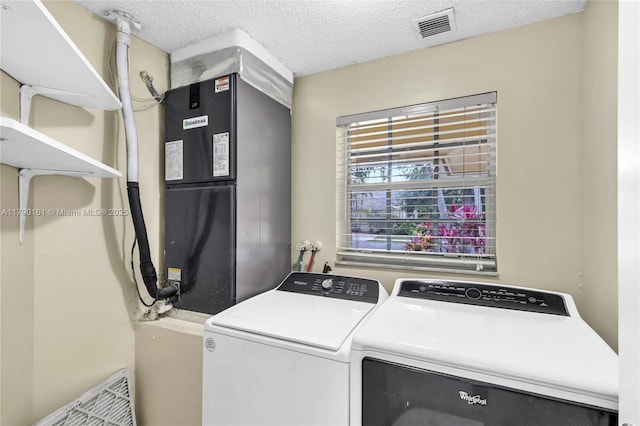 3562 W Southern Orchard Rd W, Davie, FL 33328 - laundry area with washing machine and dryer and a textured ceiling