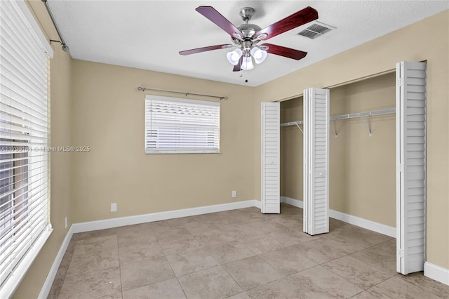 3562 W Southern Orchard Rd W, Davie, FL 33328 - unfurnished bedroom with two closets, light tile patterned floors, and a ceiling fan