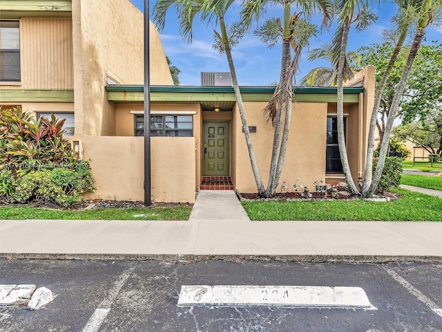 9401 NW 14th Ct Unit 224, Pembroke Pines, FL 33024 - view of front of home with uncovered parking, fence private yard, and stucco siding