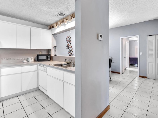 9401 NW 14th Ct Unit 224, Pembroke Pines, FL 33024 - kitchen featuring dishwasher, visible vents, a sink, black microwave, and a textured ceiling