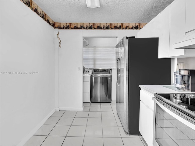 9401 NW 14th Ct Unit 224, Pembroke Pines, FL 33024 - kitchen featuring a textured ceiling, stainless steel electric range, light countertops, white cabinetry, and independent washer and dryer