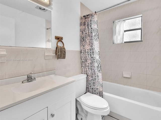 9401 NW 14th Ct Unit 224, Pembroke Pines, FL 33024 - full bathroom featuring toilet, vanity, tile walls, shower / tub combo with curtain, and wainscoting