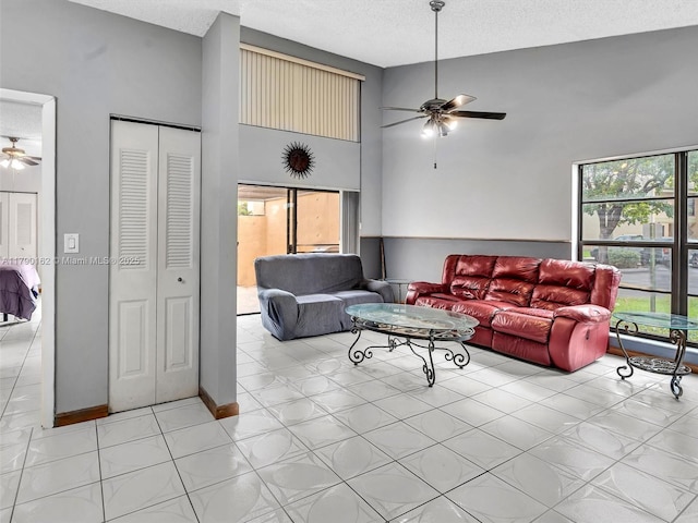 9401 NW 14th Ct Unit 224, Pembroke Pines, FL 33024 - living room featuring a textured ceiling, a ceiling fan, and a towering ceiling