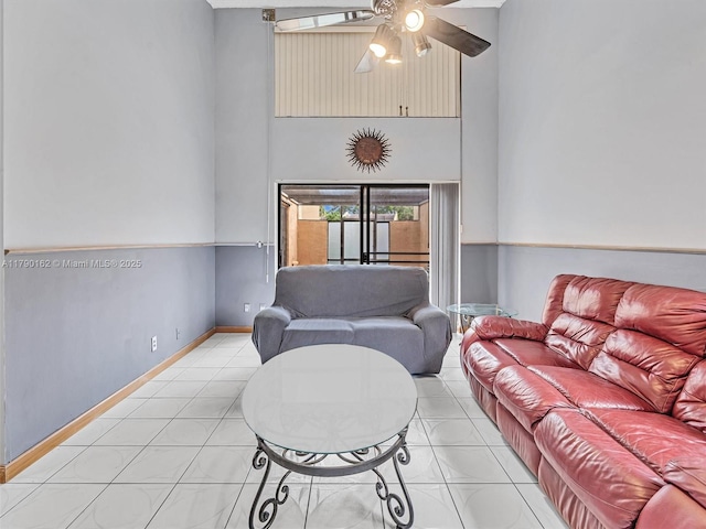 9401 NW 14th Ct Unit 224, Pembroke Pines, FL 33024 - living room featuring baseboards, a ceiling fan, a towering ceiling, and light tile patterned floors