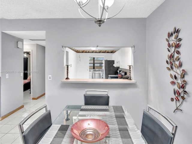 9401 NW 14th Ct Unit 224, Pembroke Pines, FL 33024 - dining space with washer / dryer, a textured ceiling, and baseboards