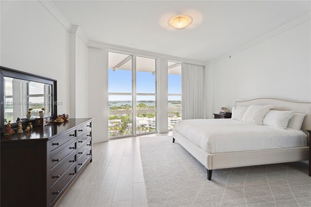 10225 Collins Ave Unit 904, Bal Harbour, FL 33154 - bedroom with light wood-type flooring, expansive windows, and ornamental molding