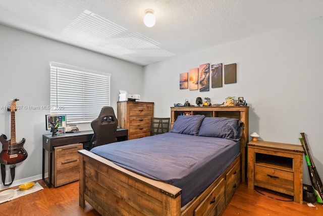 bedroom featuring wood finished floors and baseboards