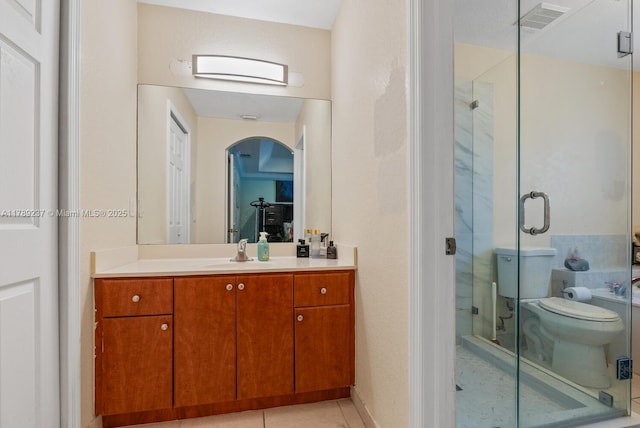 full bathroom with a shower stall, vanity, tile patterned floors, and toilet