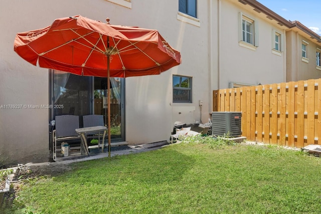 rear view of property with cooling unit and stucco siding
