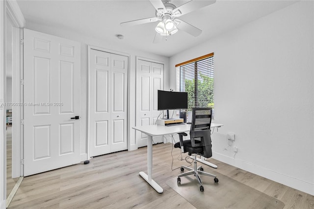 office featuring ceiling fan, baseboards, and light wood-type flooring