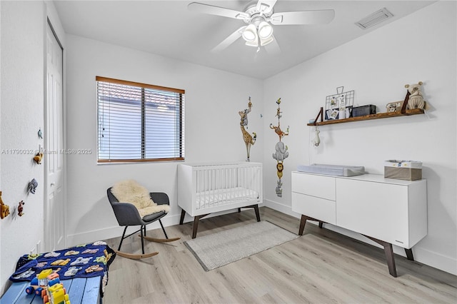 bedroom featuring visible vents, a closet, baseboards, light wood finished floors, and a ceiling fan