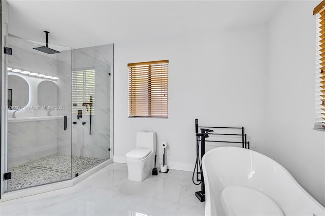 bathroom featuring baseboards, a shower stall, marble finish floor, toilet, and a soaking tub