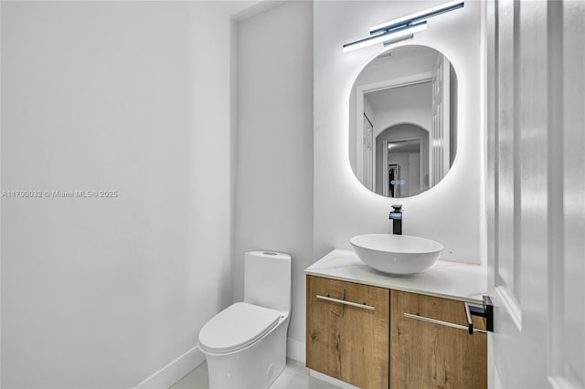 bathroom featuring toilet and vanity