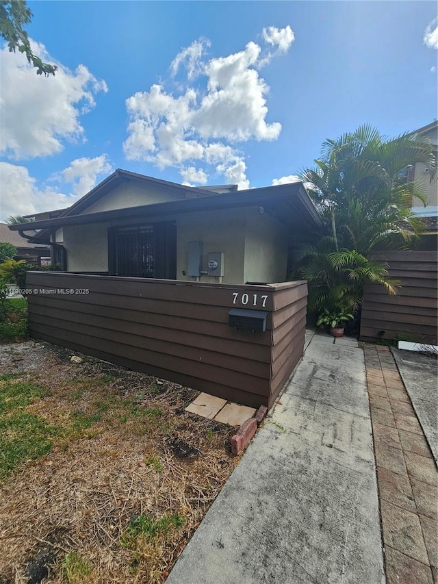 view of side of home featuring fence