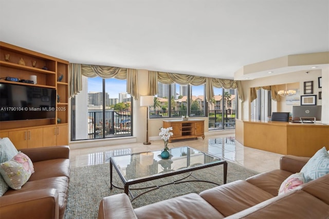 living room featuring a chandelier and tile patterned floors