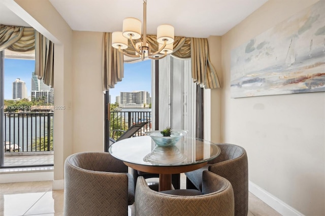 tiled dining area featuring a chandelier, a wealth of natural light, and a view of city