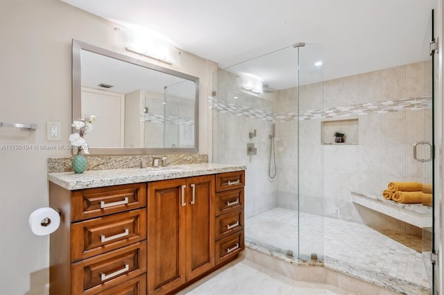 full bathroom with vanity and a stall shower