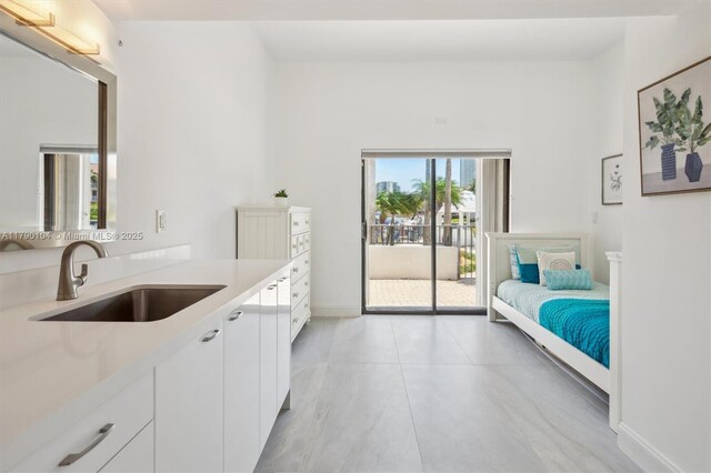 interior space with access to outside, baseboards, and a sink