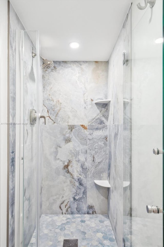 full bathroom featuring a marble finish shower