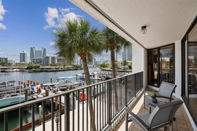 balcony featuring a city view and a water view